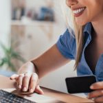 Happy young woman doing e-shopping.